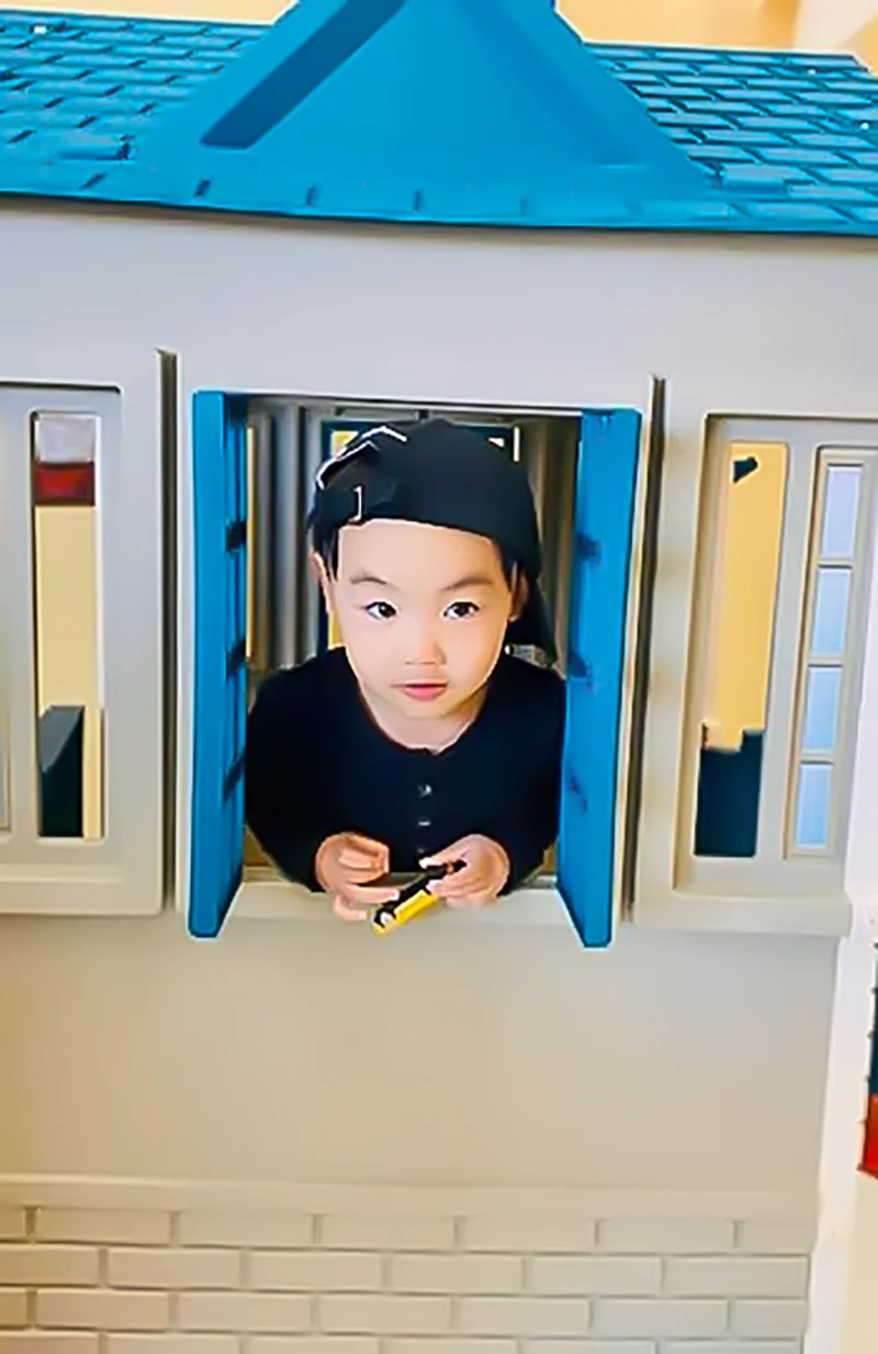 Child playing in playhouse at Lakeland Child Care.